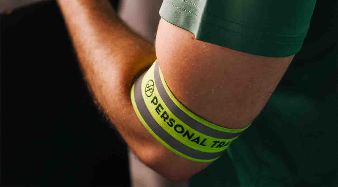 Holmes Place | man wearing personal training arm band